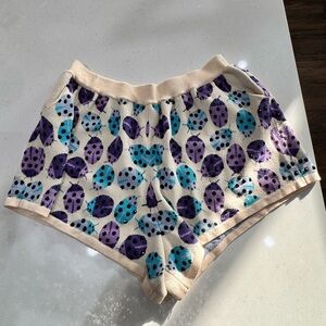 QUEEN OF SPARKLES Cream Shorts with Purple and Blue Design